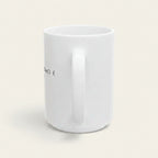 A white ceramic coffee mug with a handle, shown from a side angle against a solid pale beige background.
